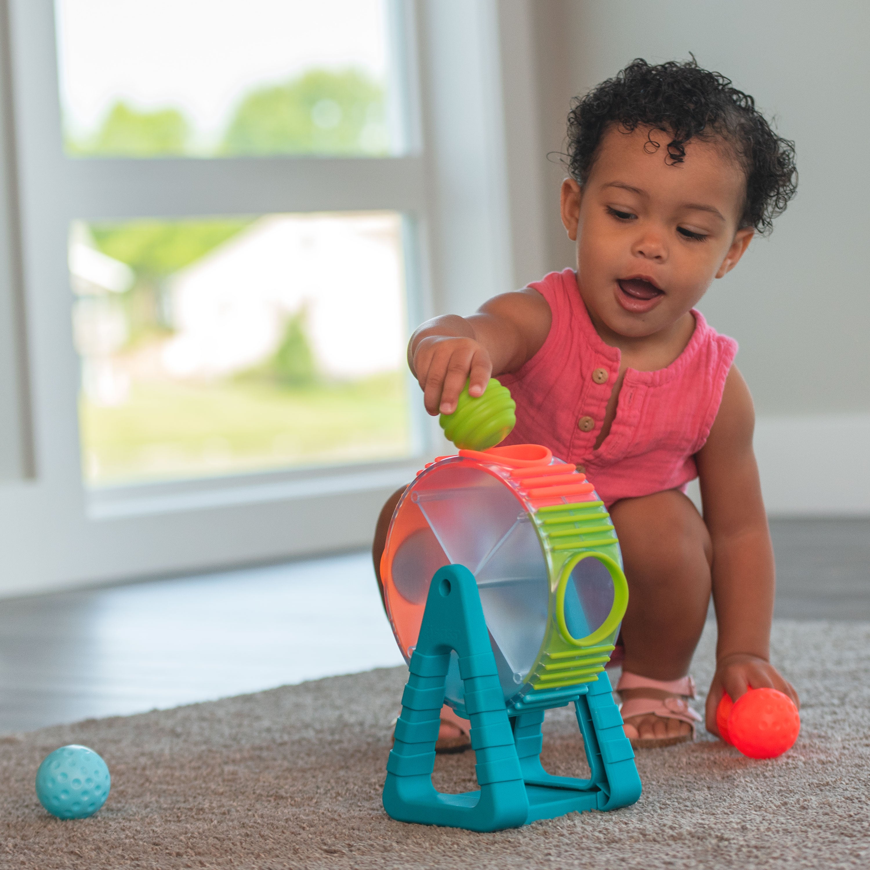 colorful spinning wheel toy with balls that drop from the sides