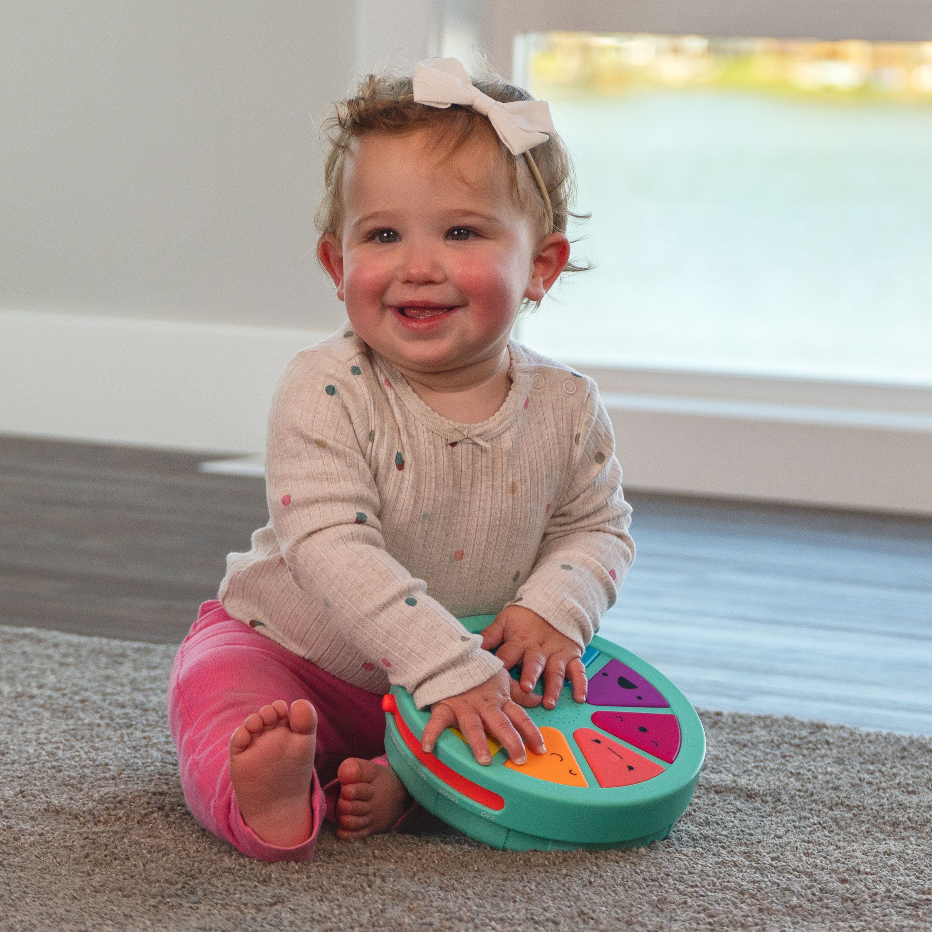 child sitting on the floor, playing with Palette of personalities toy