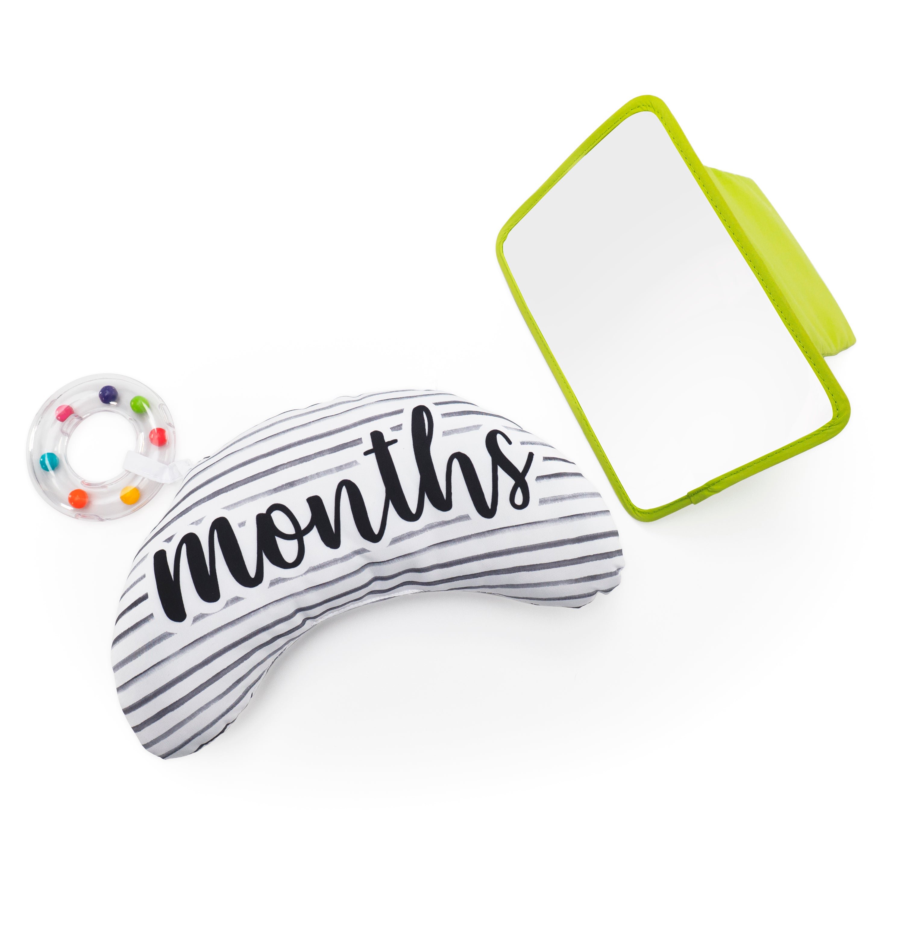 Baby milestone pillow with 'months' text and a colorful donut toy on a white background