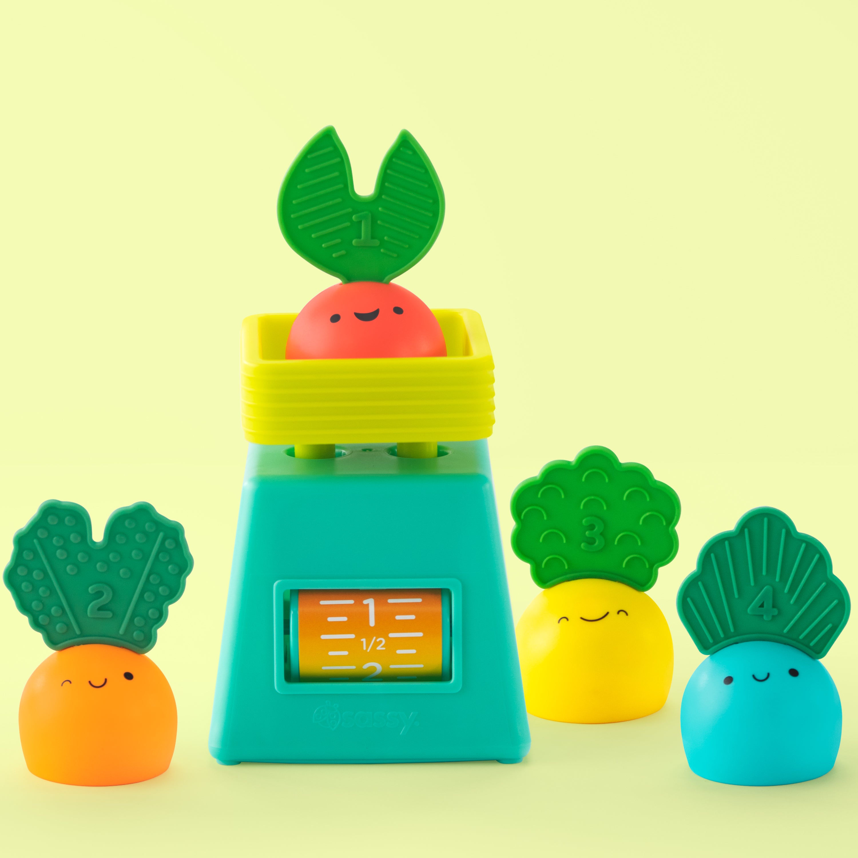 5 piece veggie stacker toy on a green background