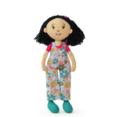 Doll with floral overalls on a white background