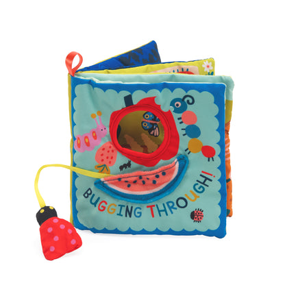 Colorful soft book with soft textures and a toy bee on a white background