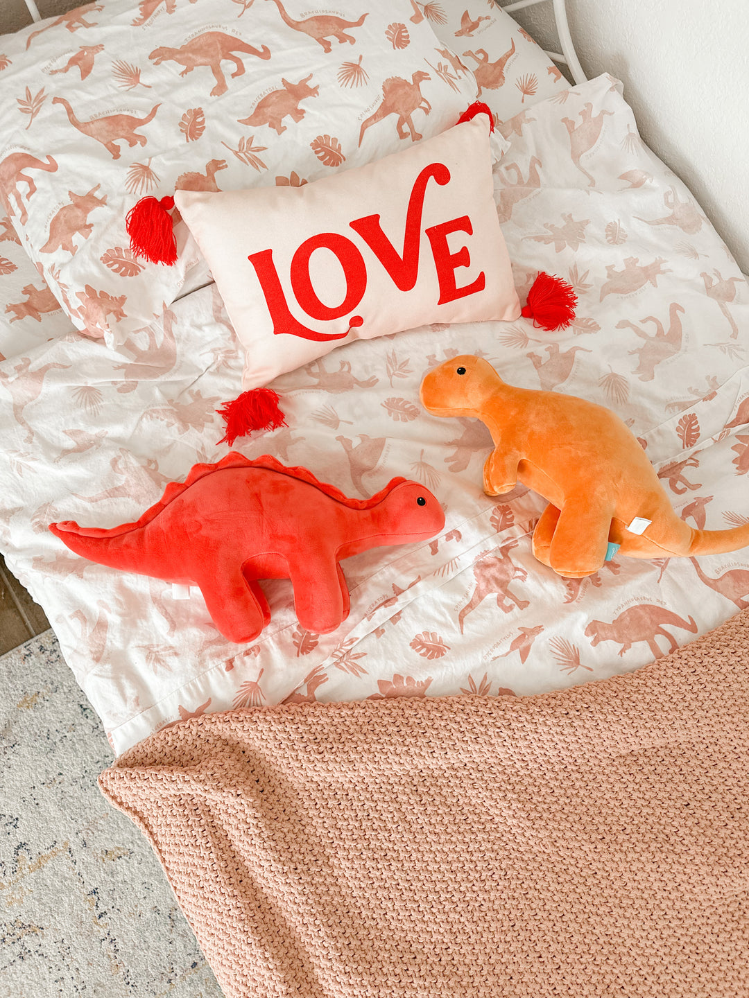 @theheinrichhouse photo from instagram - dinosaur plush toys laying in boys' bed