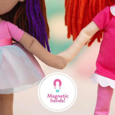 Two dolls holding hands with a 'Magnetic hands!' label in the center.