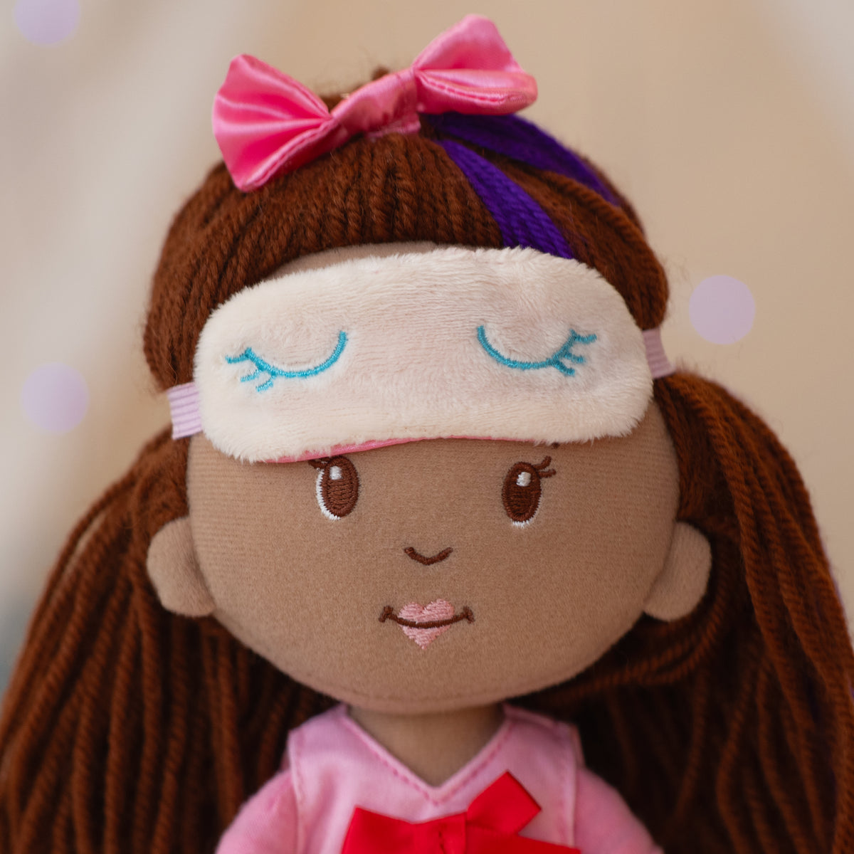 close up of doll wearing a sleeping mask on her head