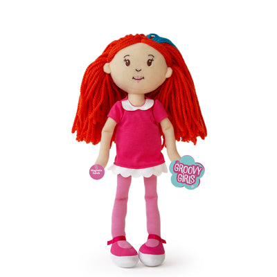 Plush doll with red hair and pink outfit and hangtags on a white background