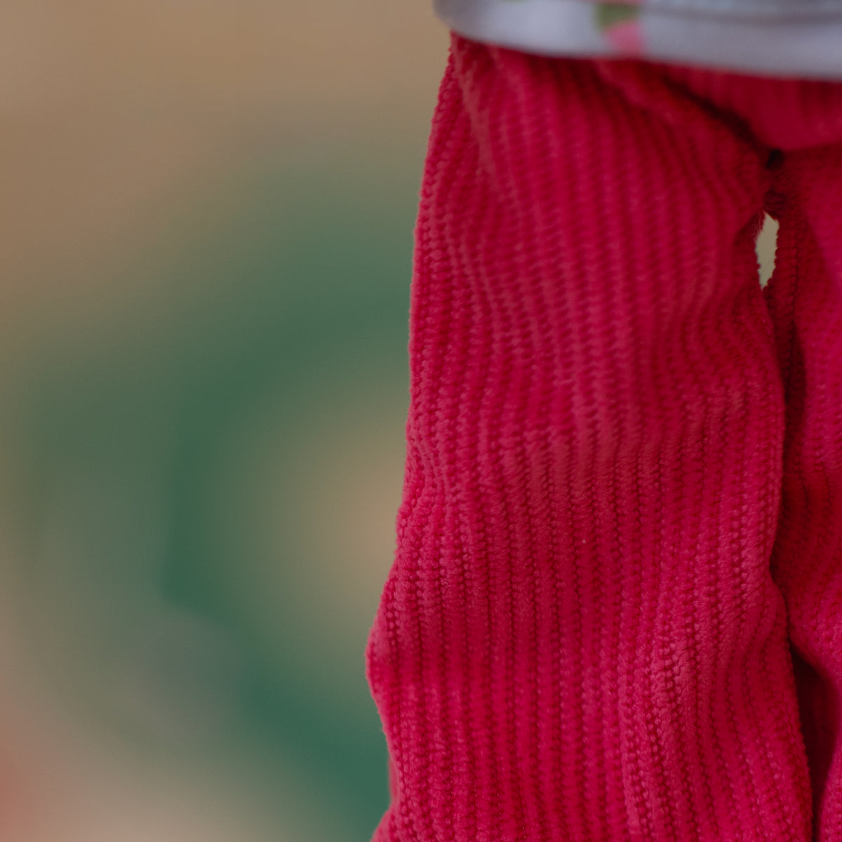 close up of doll wearing pink corduroy pants