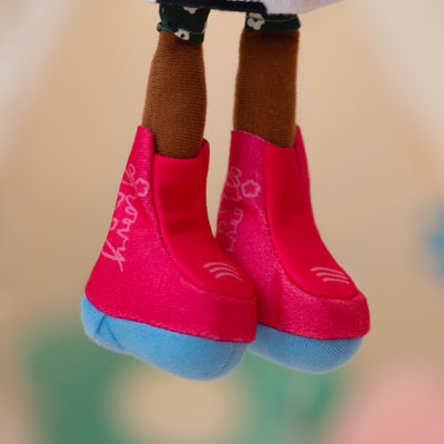 close up of soft doll wearing pink cowgirl boots