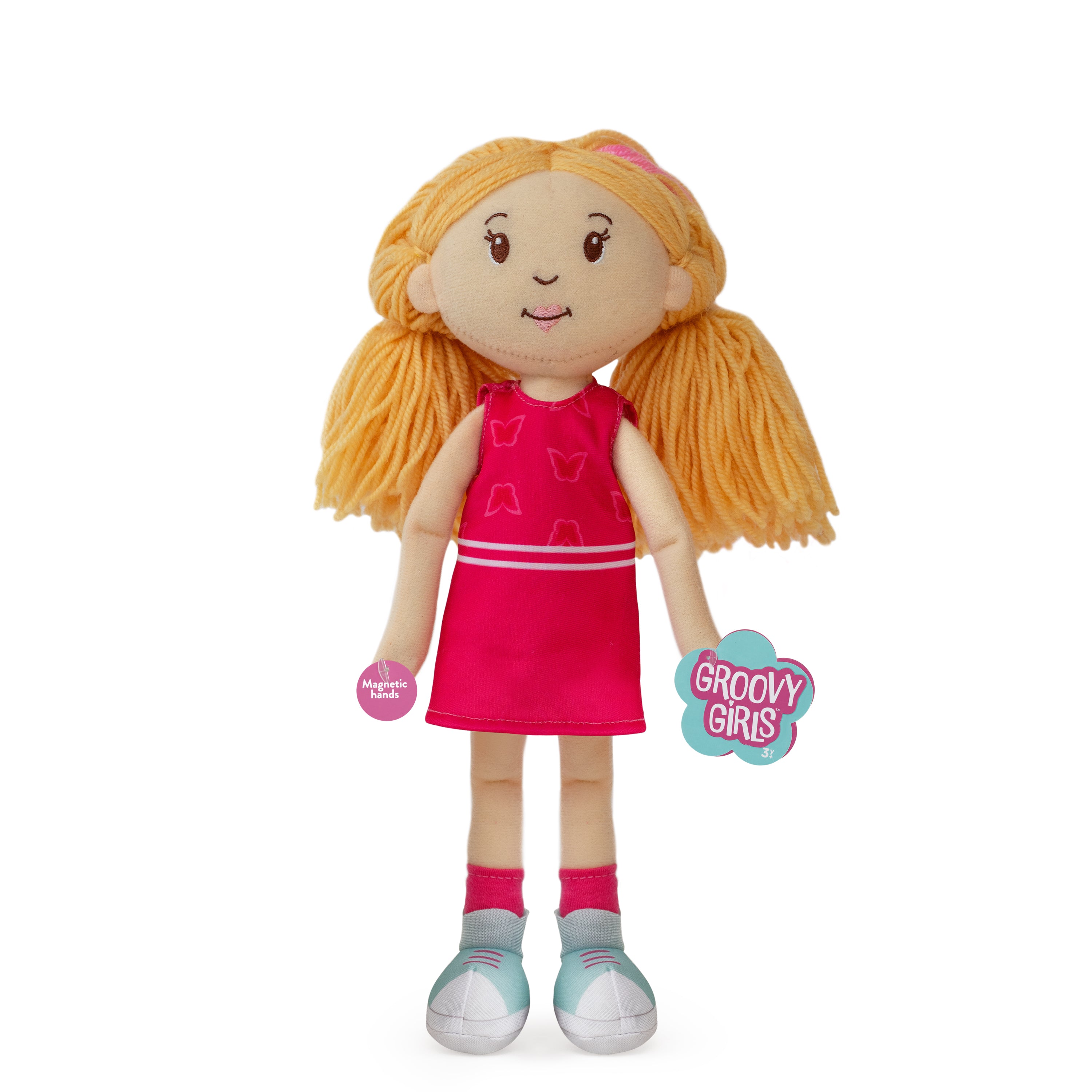 Plush doll with blonde hair, pink dress, and 'Groovy Girls' tag on a white background