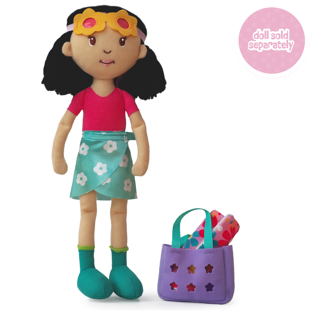 A soft doll wearing a blue floral wrap skirt, pink body suit, and yellow floral sunglasses. A purple bag  holding a floral towel sits beside her