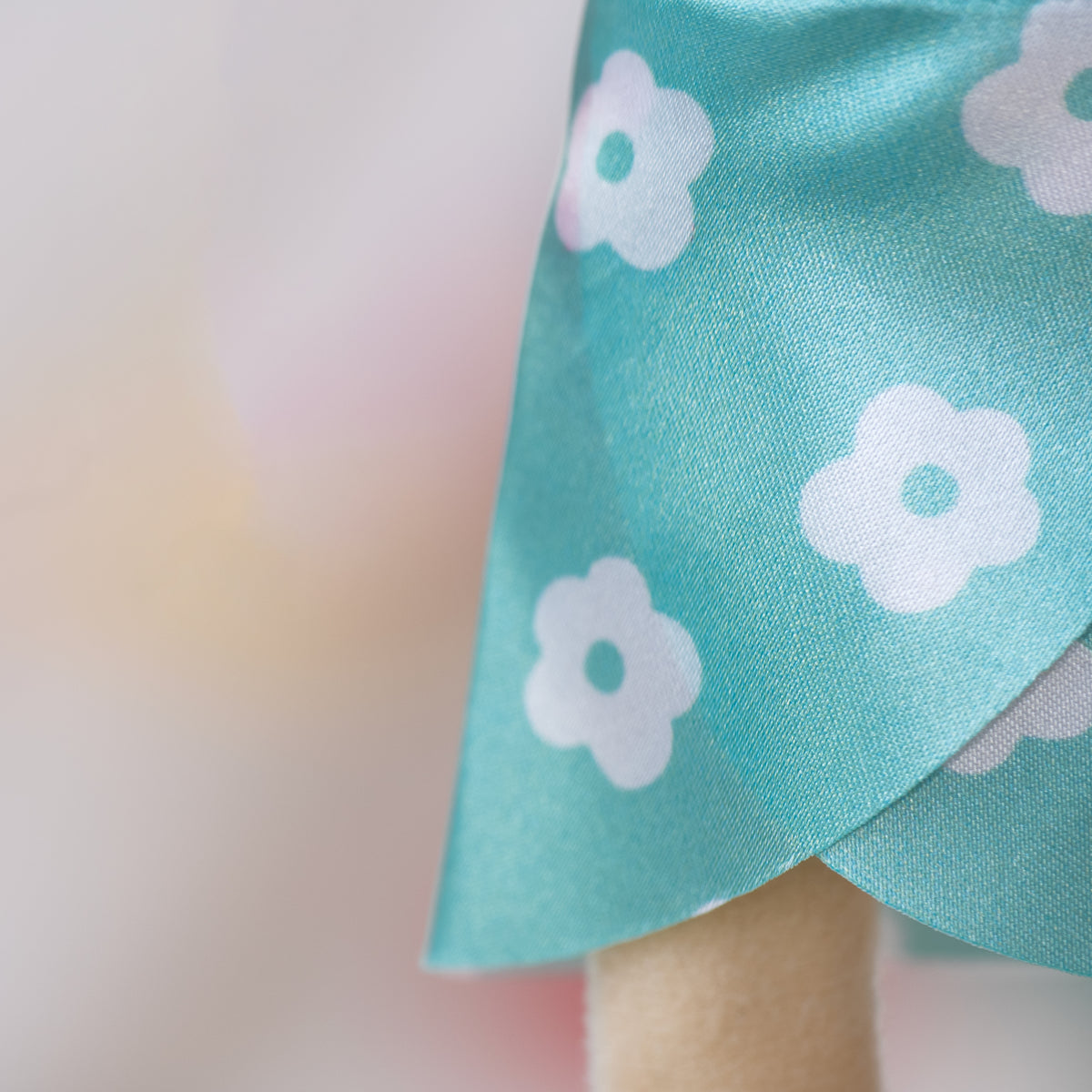 close up of a blue floral wrap skirt for a soft doll.