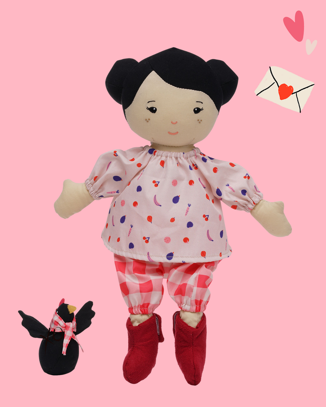 black haired soft doll in red and pink outfit