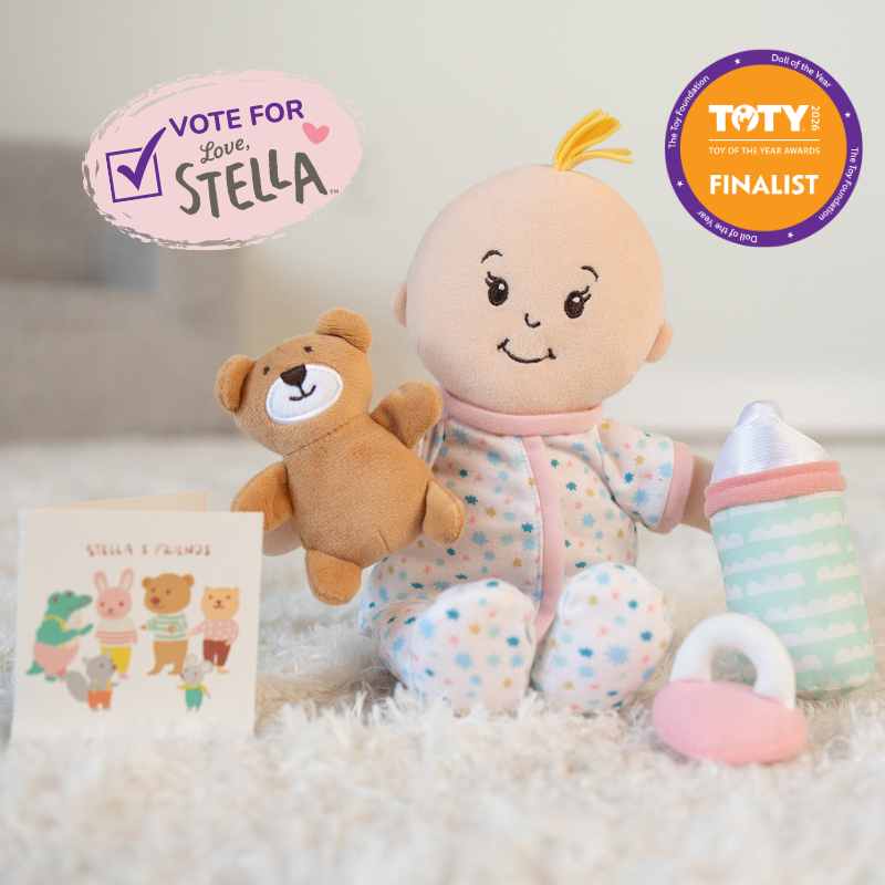 Plush Stella doll in star print pajamas with teddy bear, bottle, pacifier, and a Vote for Love Stella badge alongside a TOTY Finalist badge.