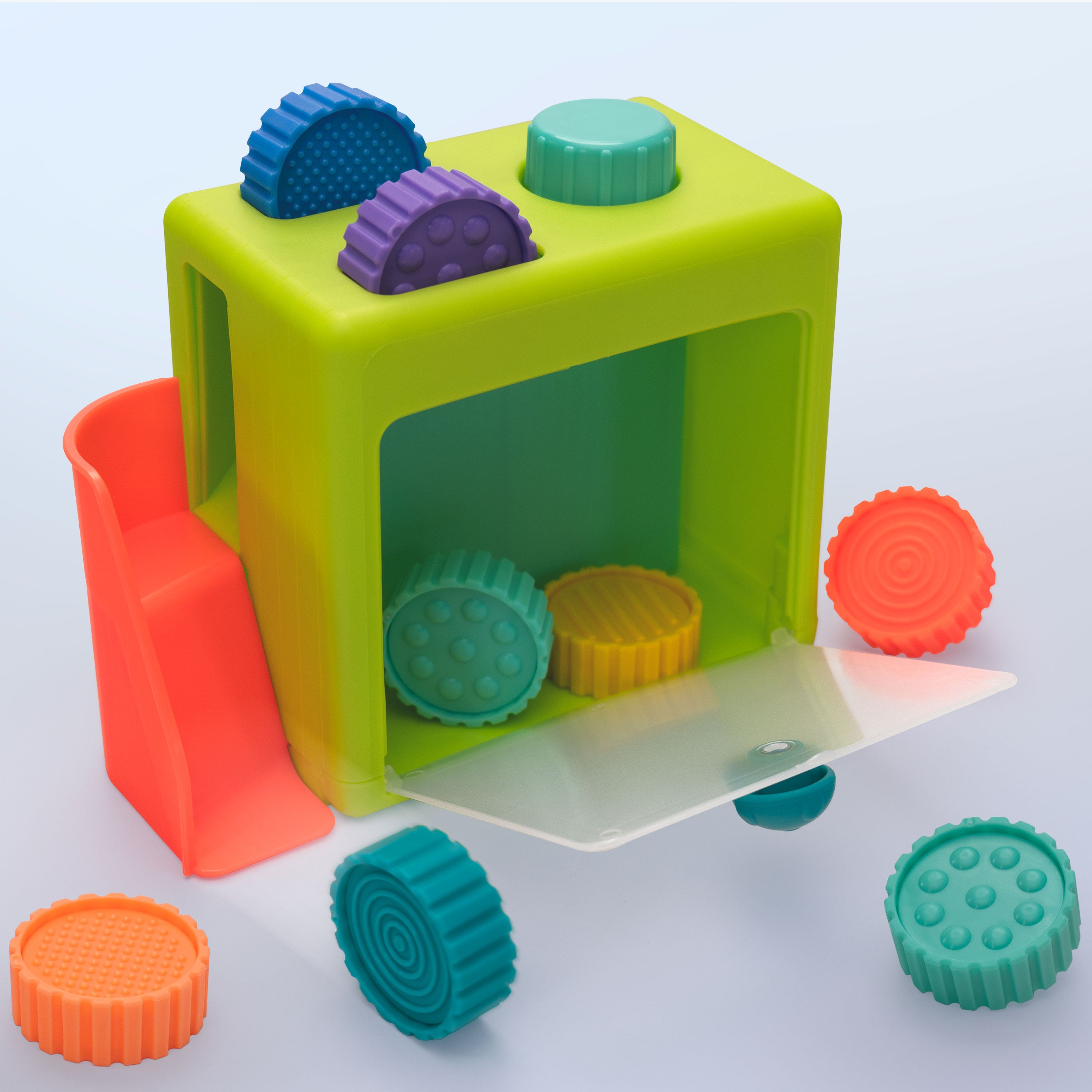 Colorful plastic toy set with various shapes on a light blue background