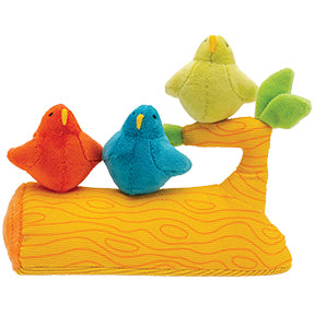 Three plush birds sit on a plush orange tree branch toy with green leaves, one red, one blue, and one green.