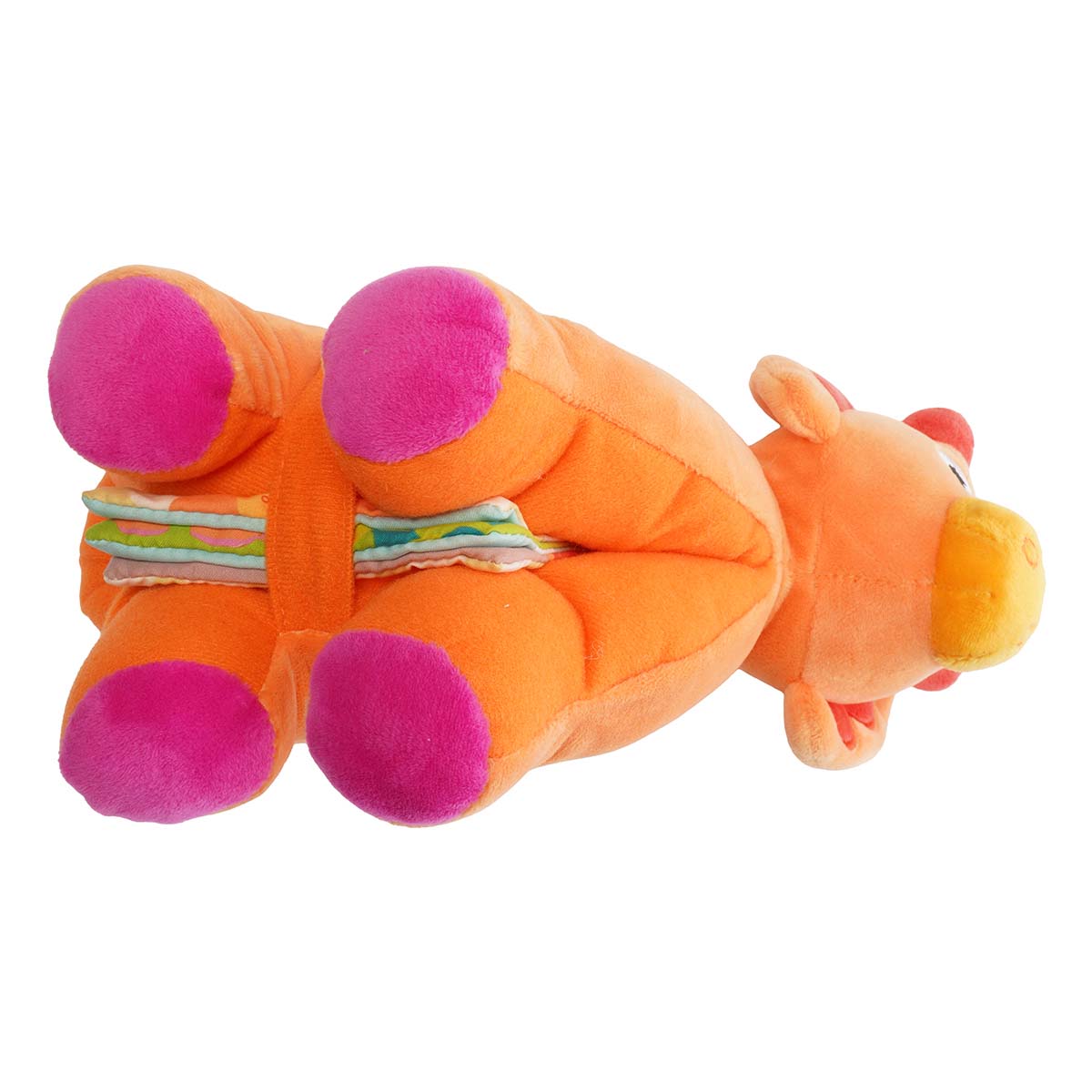Underside view of plush orange dinosaur with a baby book folded together on its belly and a velcro strap to keep it closed.