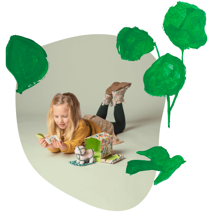 little girl playing on the ground with Manhattan Toy Bed & Biscuit Lhasapoo toy