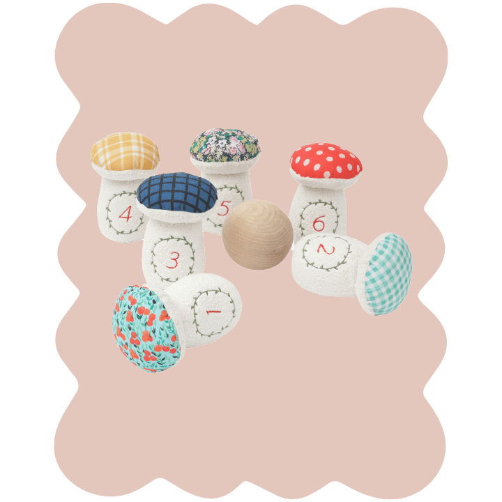 Manhattan Toy Toadstool Bowling Set on pale rose background