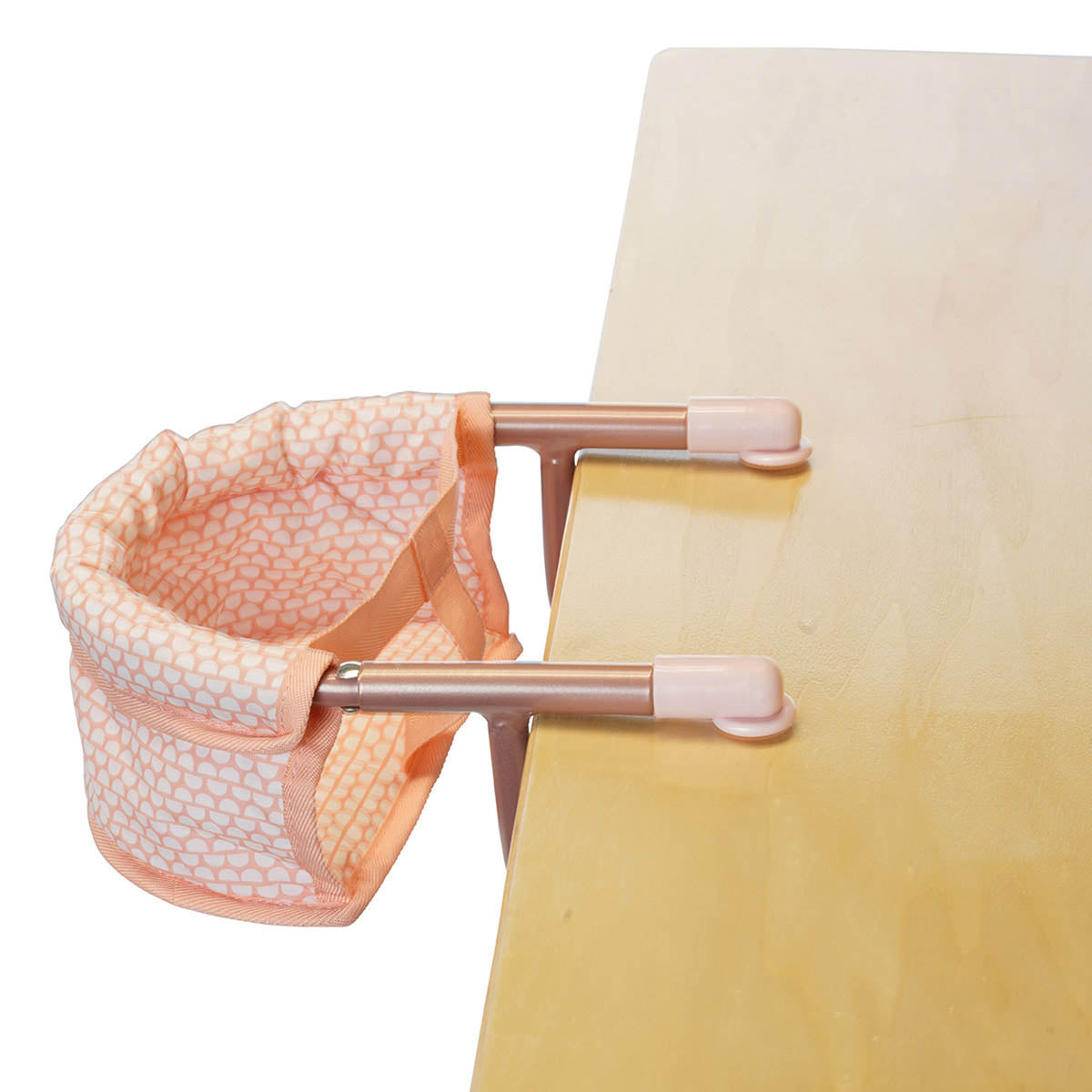 An aluminum pink doll table chair attached to a table. 