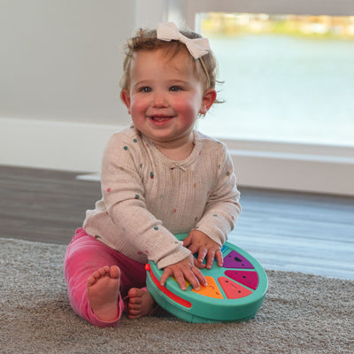 little girl playing with palette of personalities on the floor