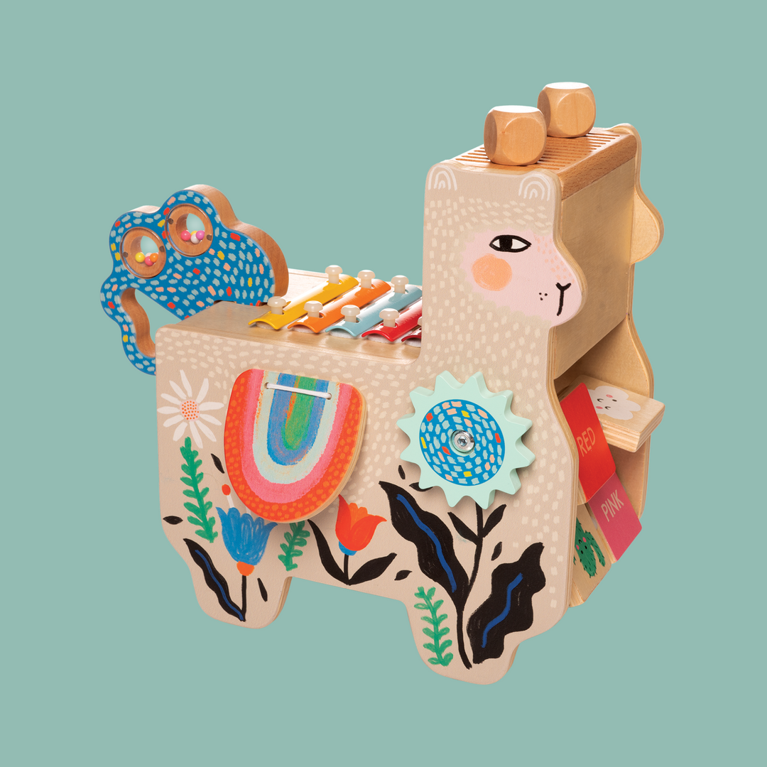 Musical wooden llama is loaded with musical toy instuments.
