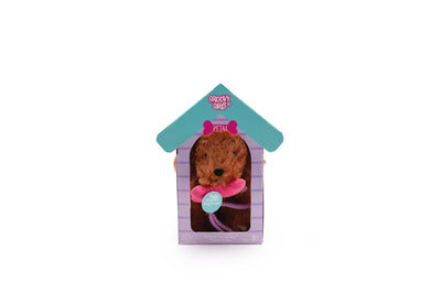 Brown soft dog with pink magnetic bone in its mouth. Inside of a doghouse package.