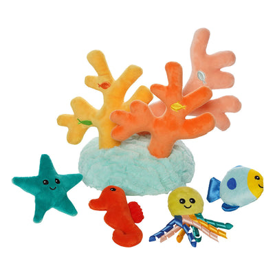 Plush coral branches have colored fish shaped spots that match those of the sea creatures, which lay in front of the coral.