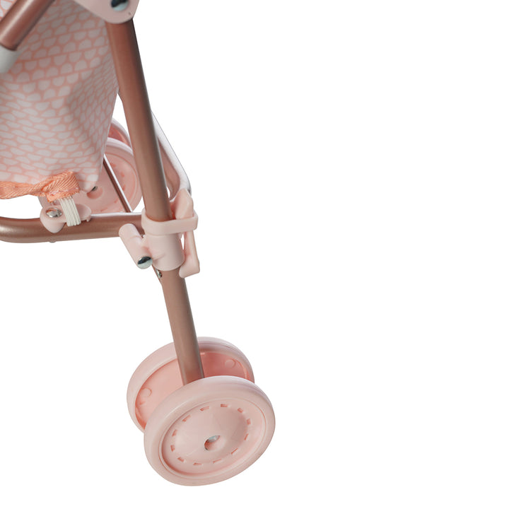 A close up of the latch to collapse a pink doll stroller. 