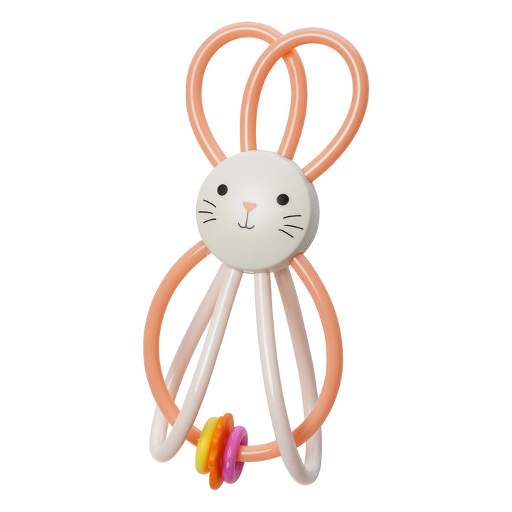 A rattle toy with a bunny face in the center and pink cords looped on top and bottom with three colorful beads.