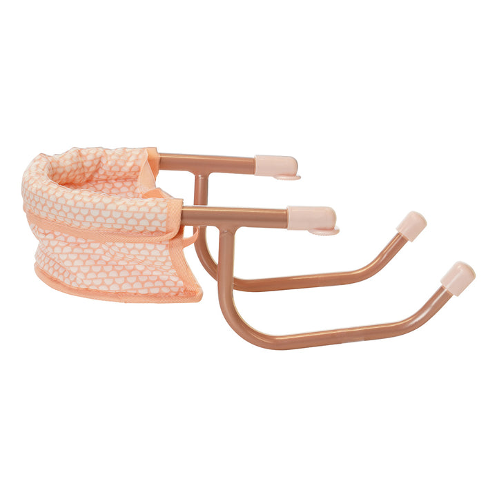 Side view of an aluminum pink doll table chair.