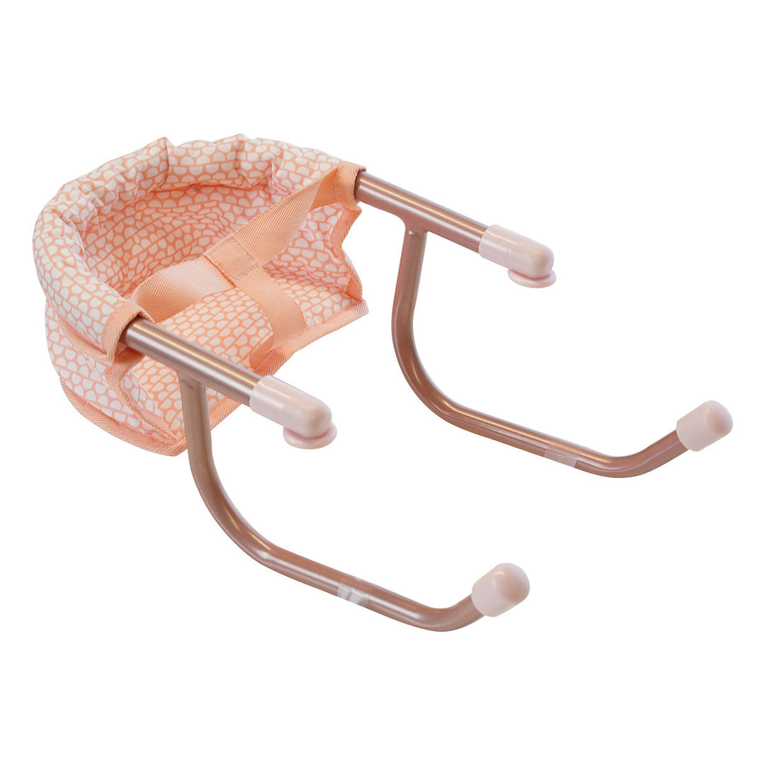 Angled view of an aluminum pink doll table chair.