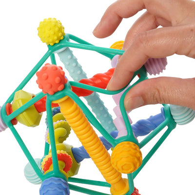 Fingers pinch the soft plastic cording of Whirzle toy to show its flexibility.