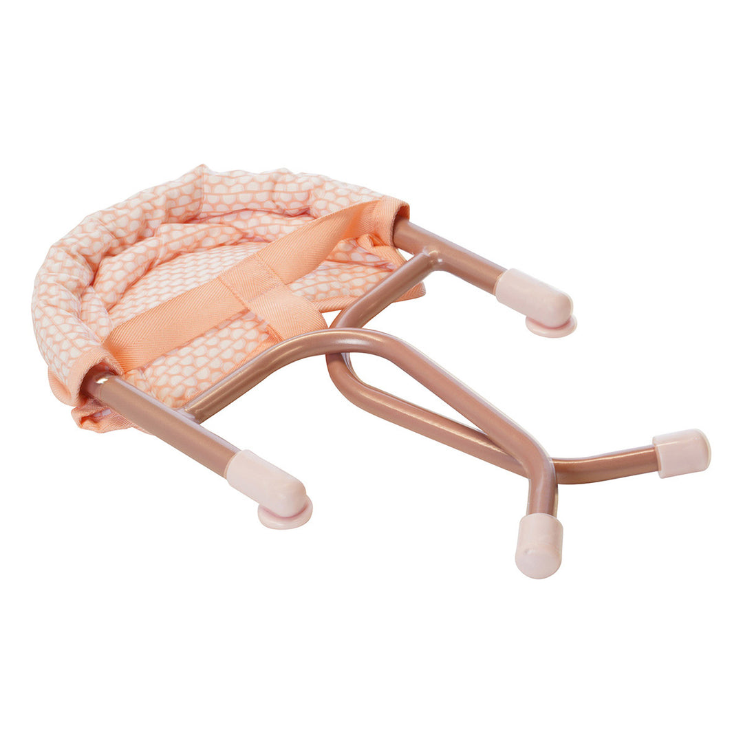 A pink doll table chair folded up for easy storage. 