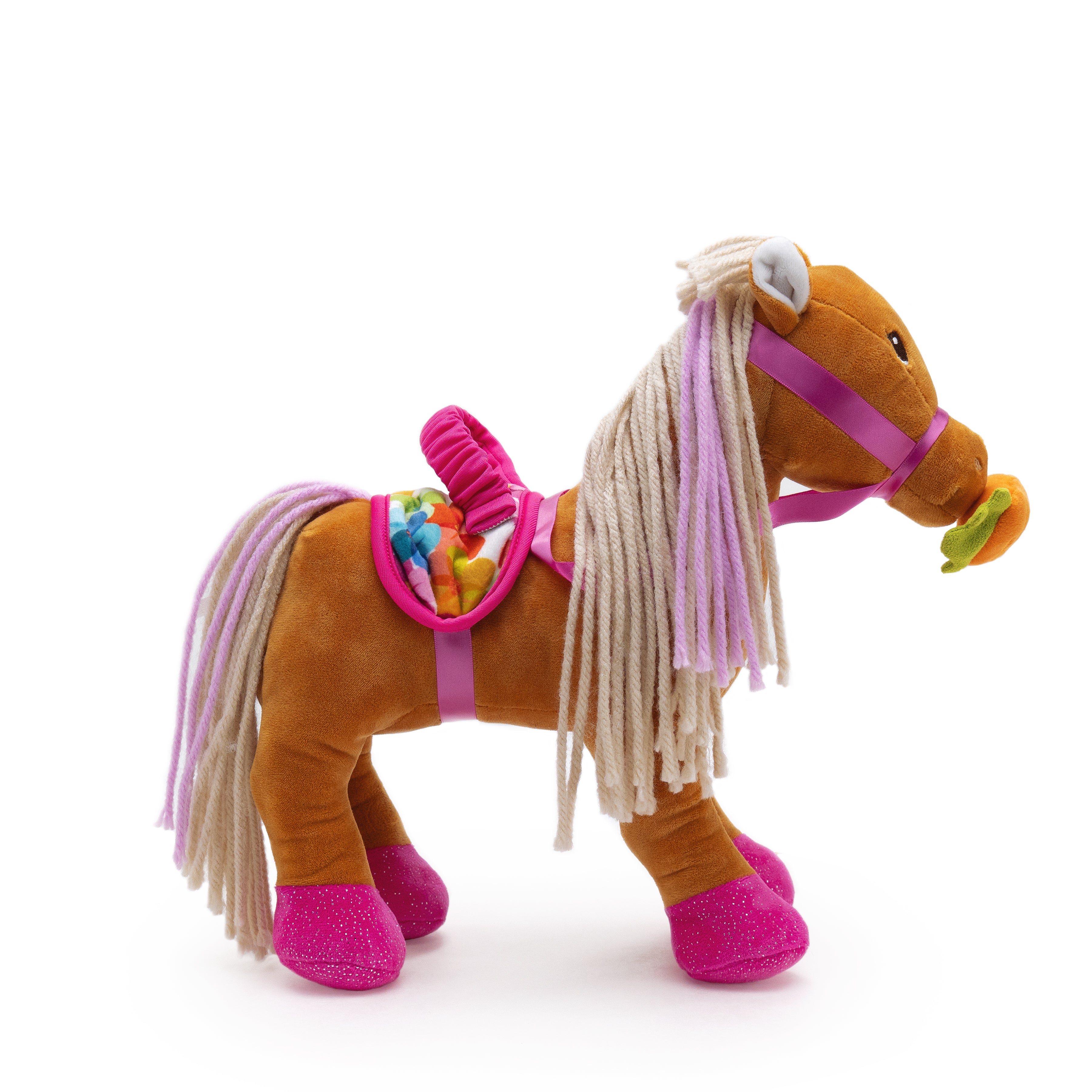 Soft brown horse with pink hooves, multicolored saddle, and a carrot in its mouth.
